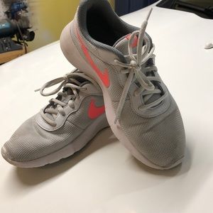 White with pink Nike running shoes